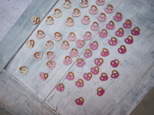 Top view of white to pink ombre dipped pretzels. 