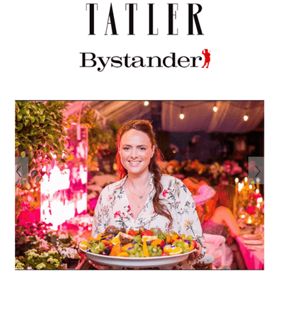 Top text: Tatler Bystander. Photo of Dani Tucker holding plate full of fruits. 