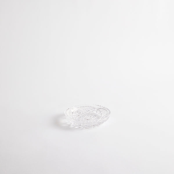 Clear glass shallow dish with etched design.