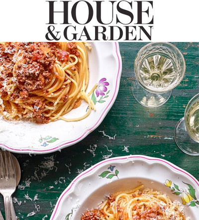 Text at top: House & Garden. Top view of spaghetti in vintage bowls on green table. 