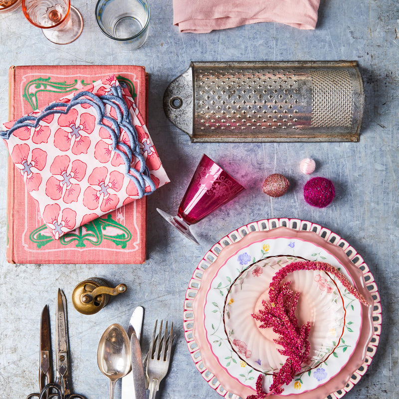 Top view of mixed pink table settings on a concrete table. 
