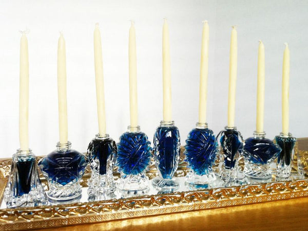 Chanukah Menorahs with white candles and blue vases. 