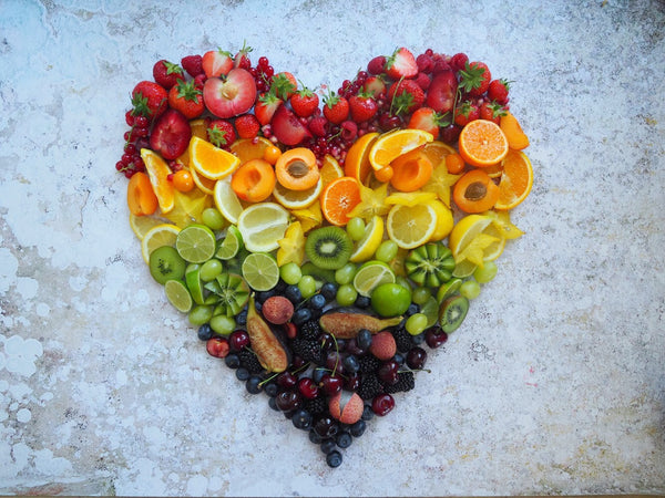 Rainbow fruit in the shape of a heart.