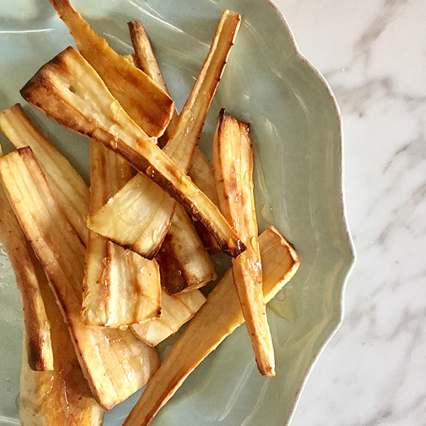 Top view of Honey Glazed Parsnips in a light green bowl.