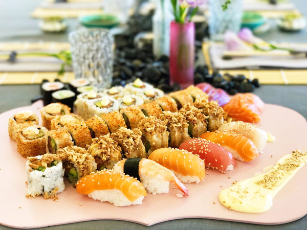 Plate full of multiple types of sushi. 