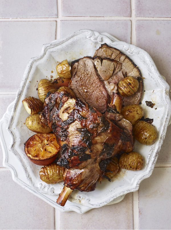 Top view of roasted lamb on white dish. 