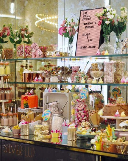 Shelves filled with variety of candy and sweets. 