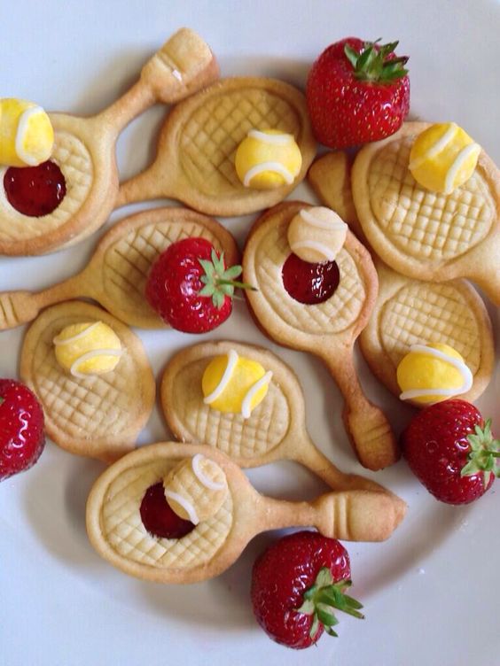 Top view of tennis racket biscuits with fruits. 