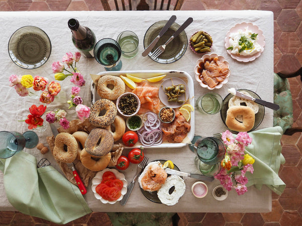 Brunch tablescape with bagels, salmon, cream cheese