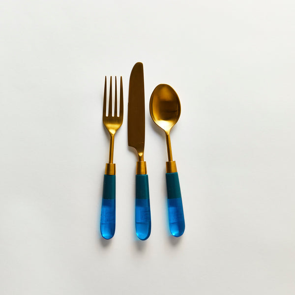 Gold serving cutlery with blue handle.