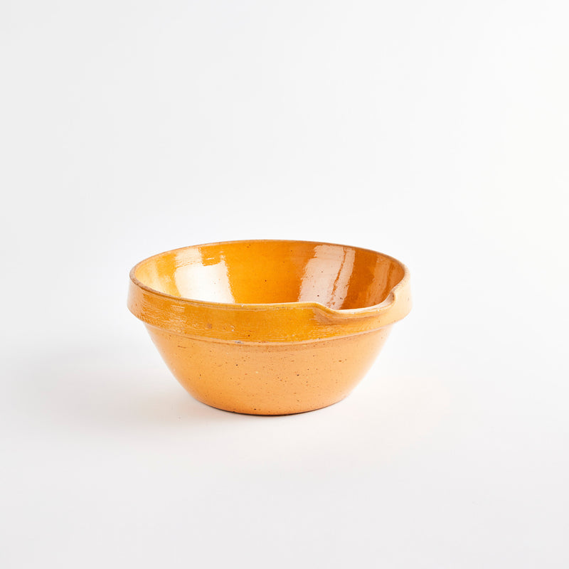 Beige bowl with spout.