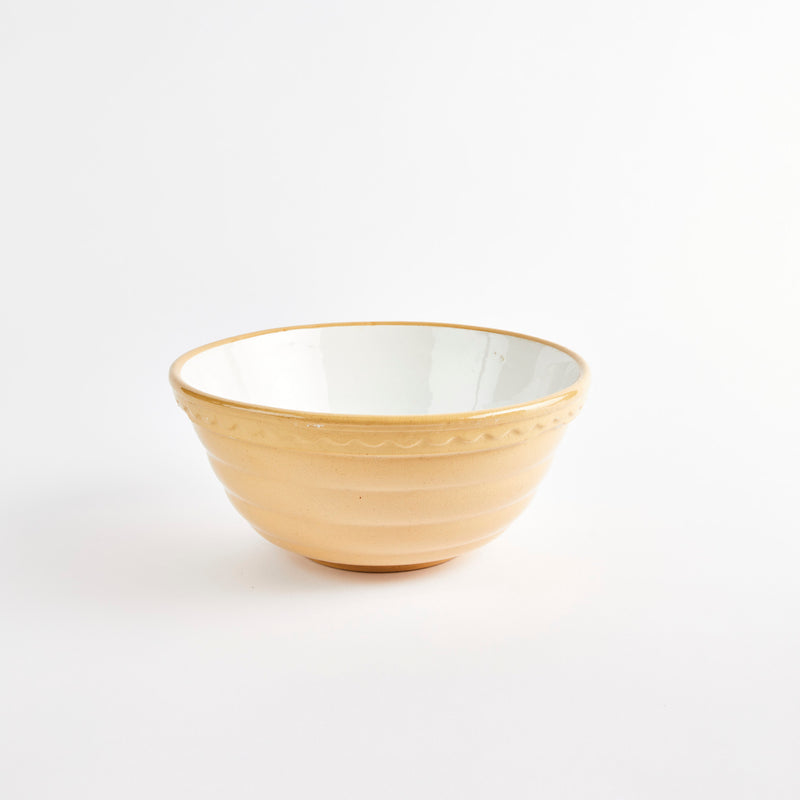 Beige bowl with white interior.