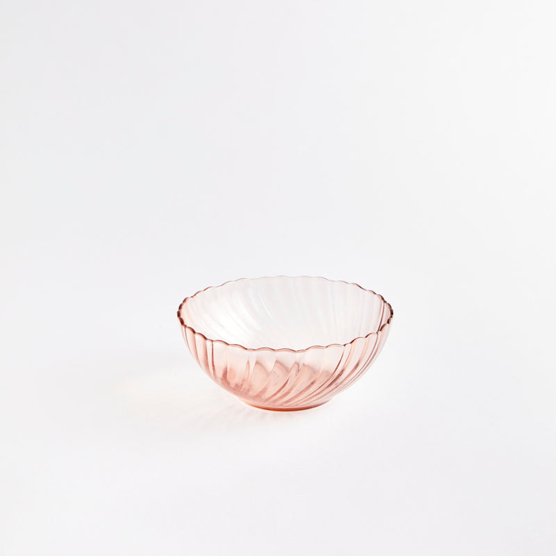Pink glass bowl with wavy design.