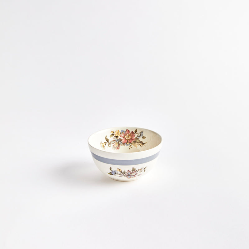 White bowl with blue stripe and floral design.