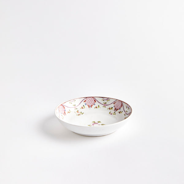 White china bowl with pink floral design.