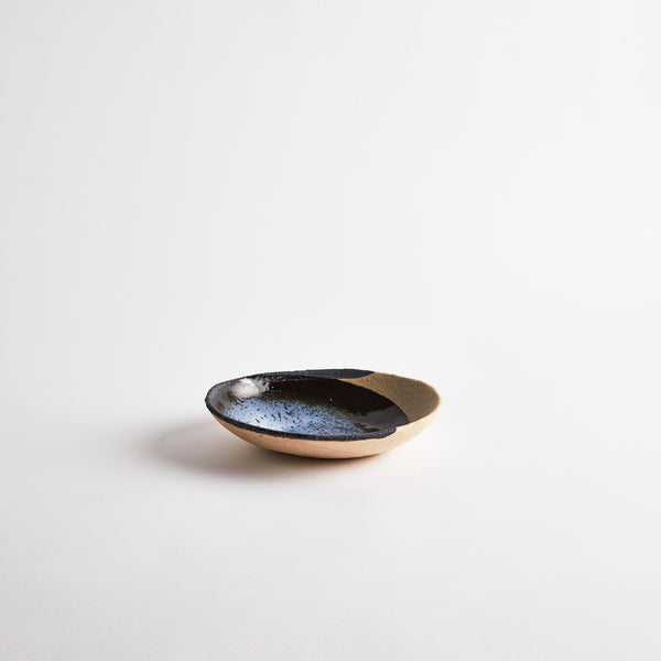 Natural ceramic bowl with blue and black glaze.