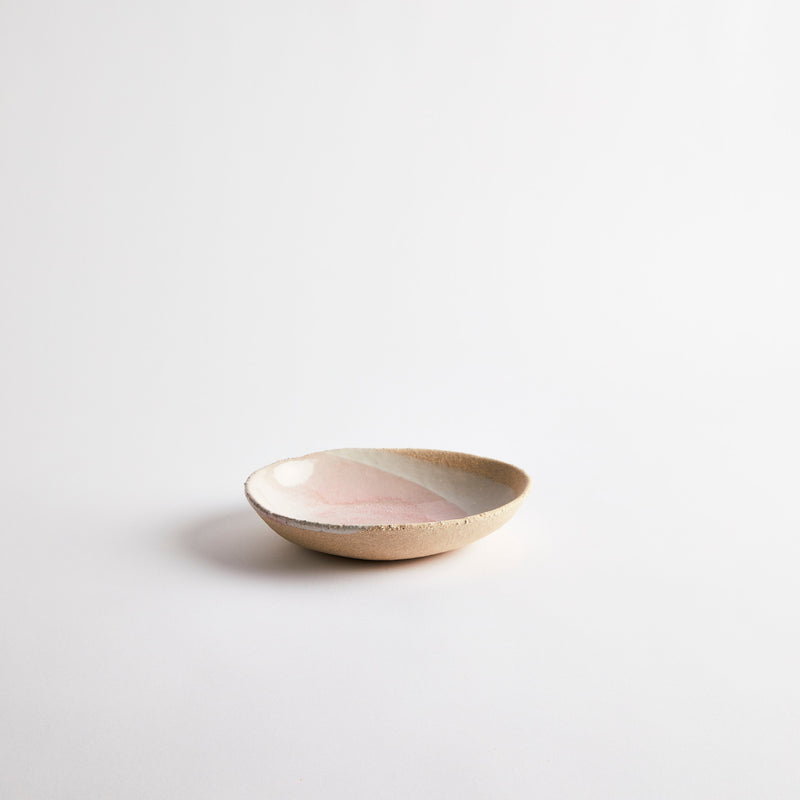 Natural ceramic bowl with pink and white glaze.