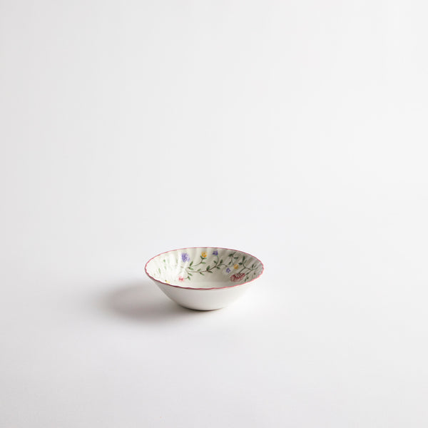 White bowl with inside floral pattern and pink rim.