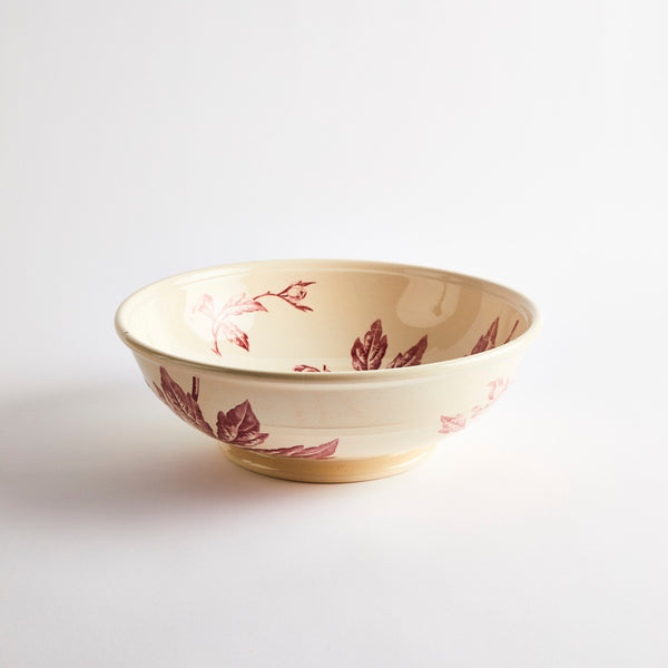 Cream bowl with burgundy floral pattern.
