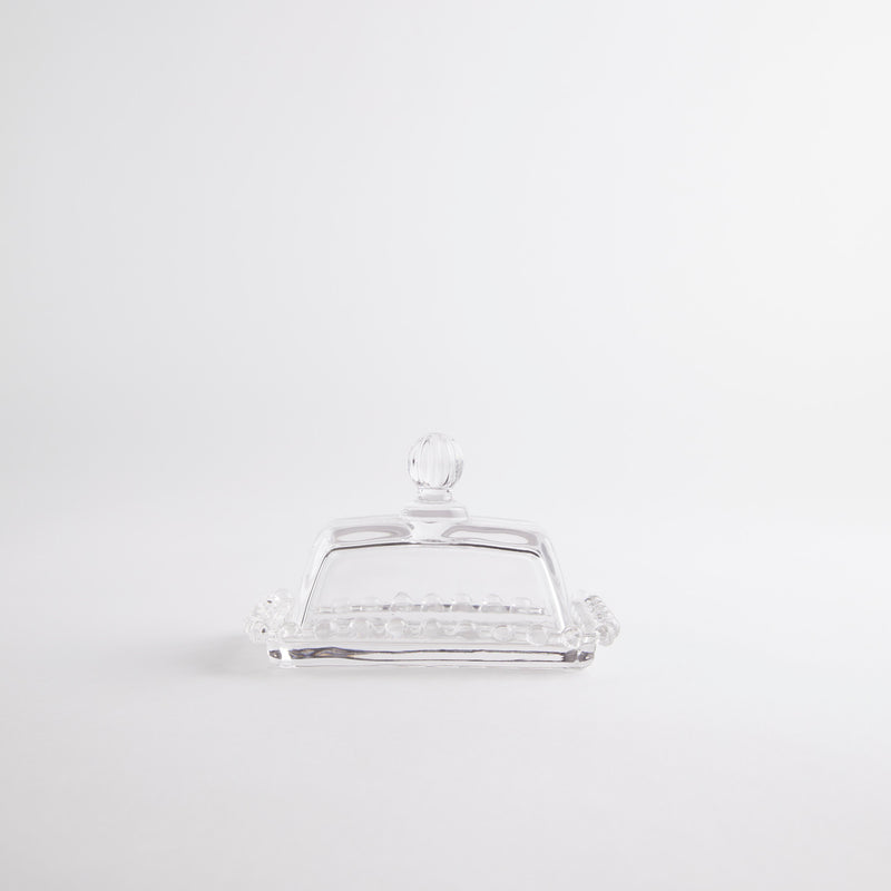 Modern clear glass butter dish with ball handle lid. 