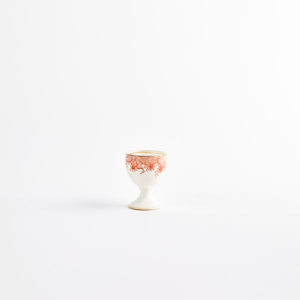 Cream with orange floral design egg cup.