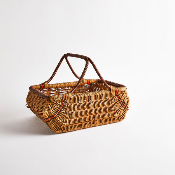 Brown wicker basket with orange stripe detail.