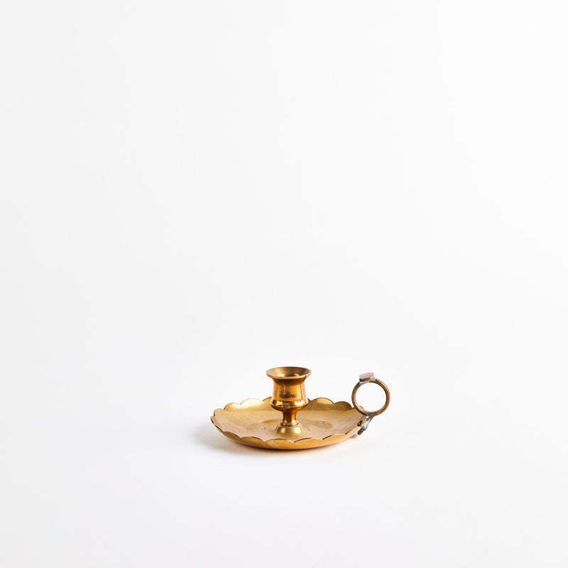 Gold candle holder with handle.