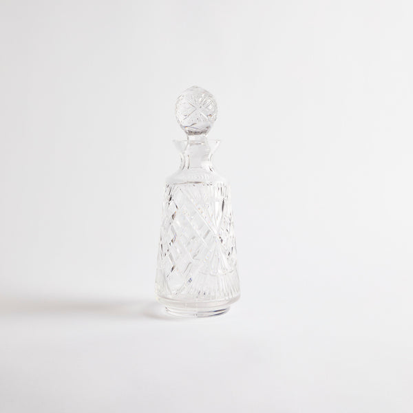 Clear glass decanter with etched design.