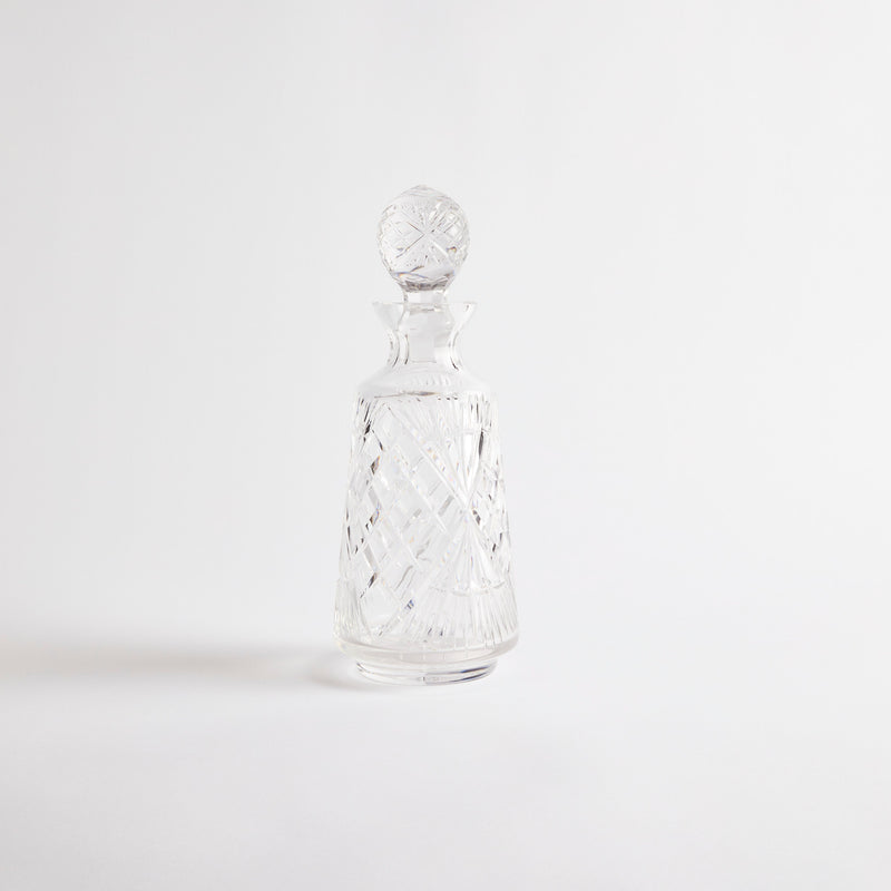 Clear glass decanter with etched design.