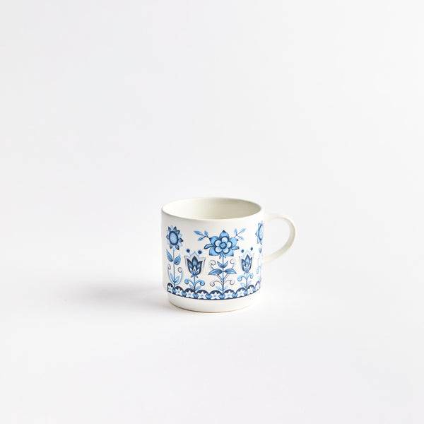 White coffee cup with blue floral design.