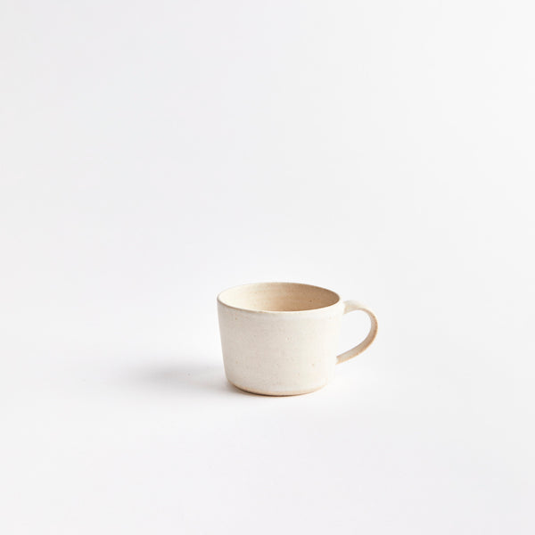 Matte cream ceramic coffee cup.