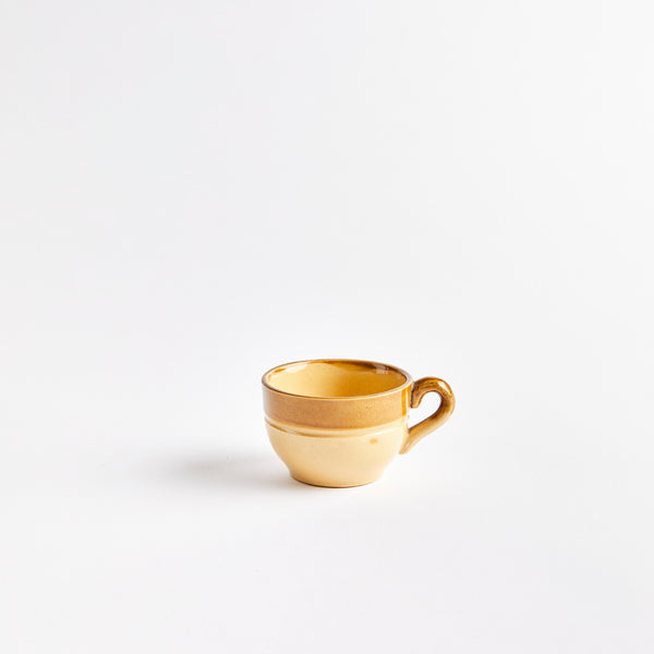 Brown ceramic coffee cup.