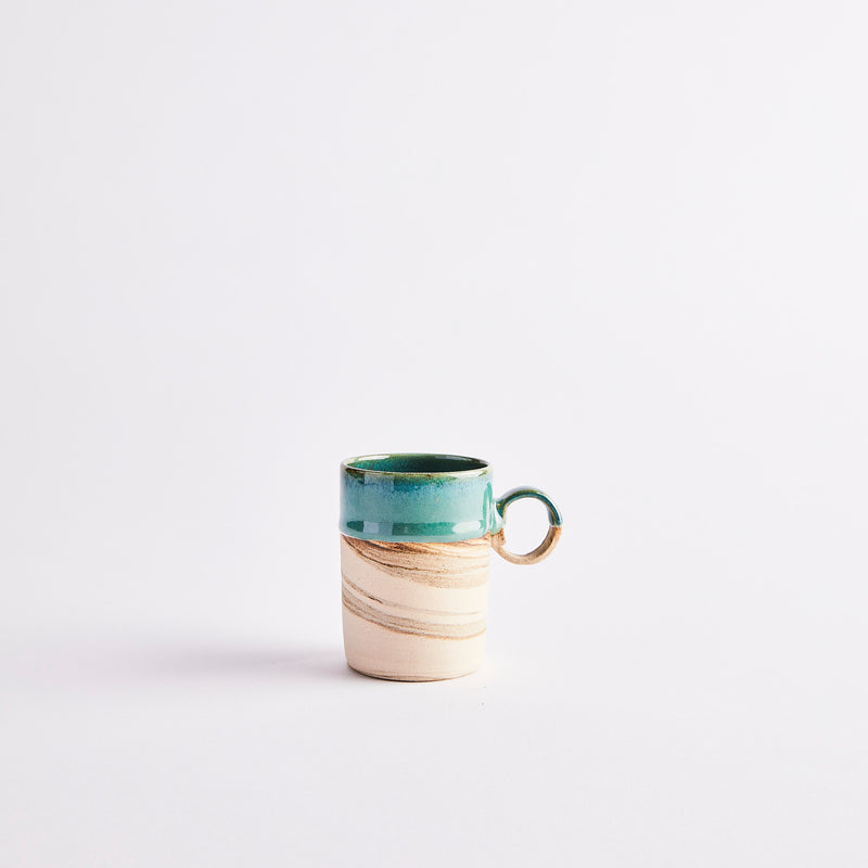 Cream and green coffee cup.