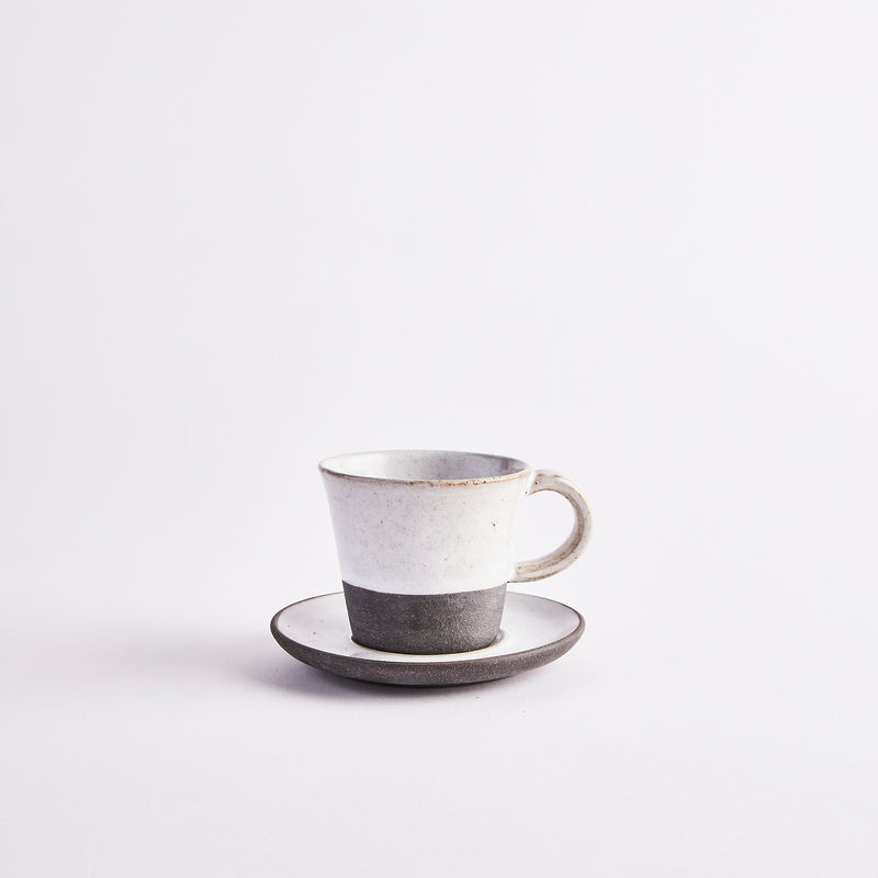 White and grey coffee cup and saucer.