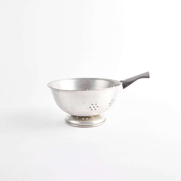 Silver metal colander with black handle.