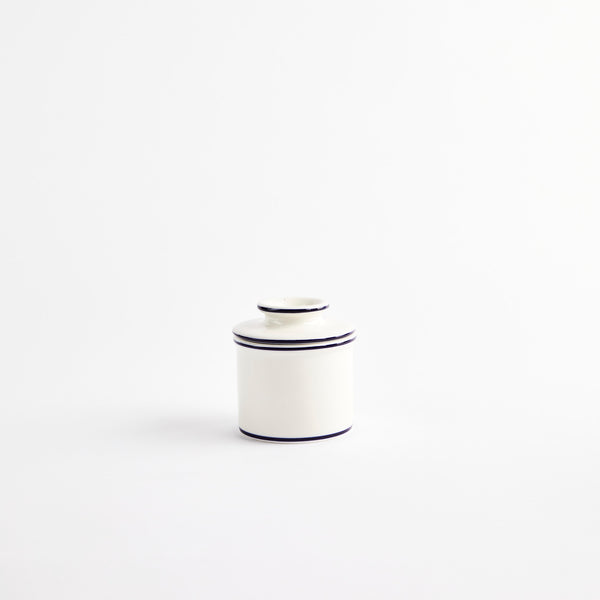 White ceramic container with black detailing.