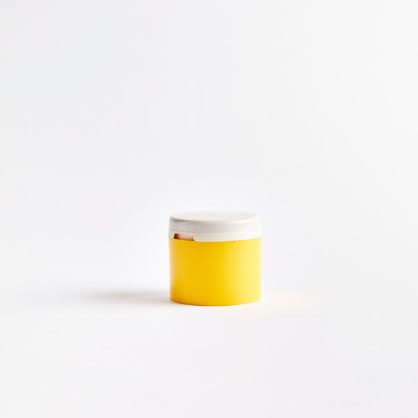 Yellow plastic container with white lid.