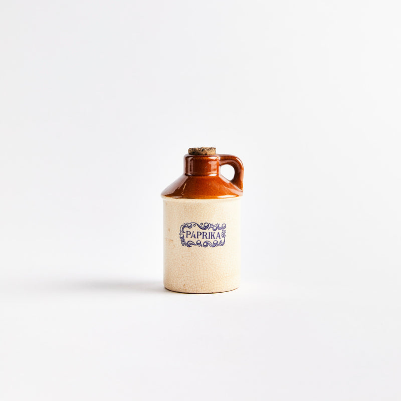 Beige and brown ceramic container with "Paprika" in blue text.