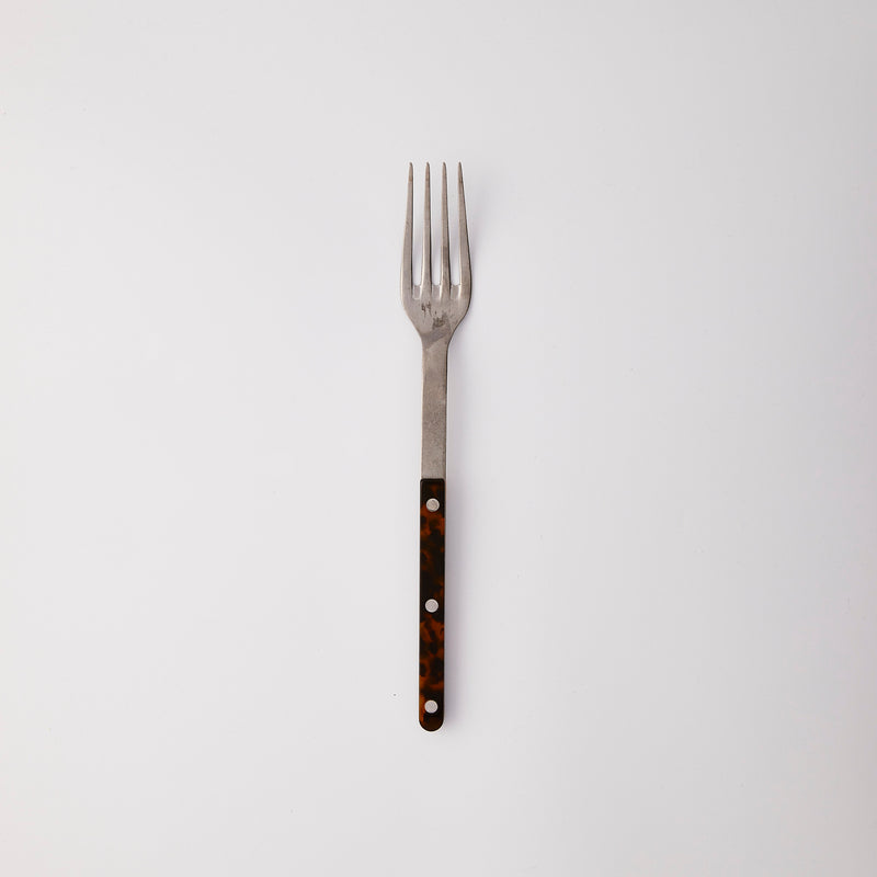 Silver fork with black handle.