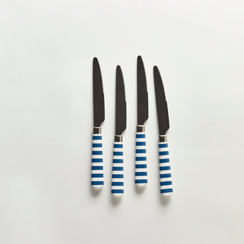 Four silver knives with white and blue striped handle.