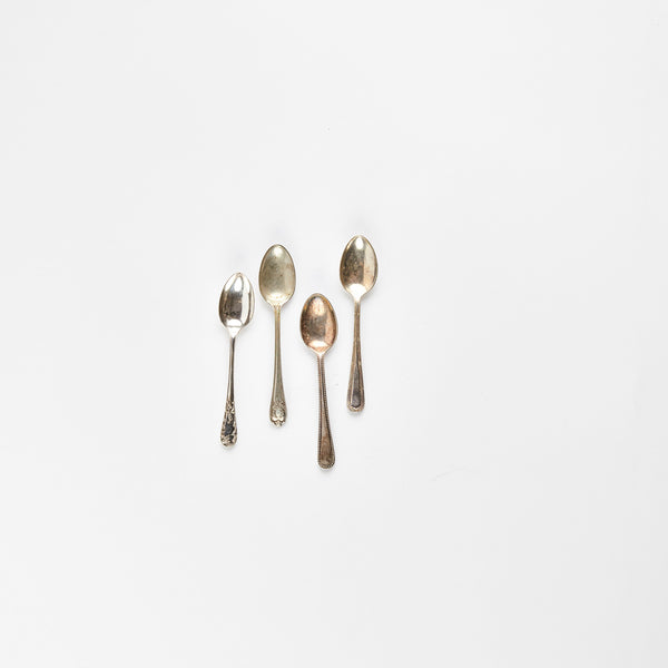 Four silver teaspoons.