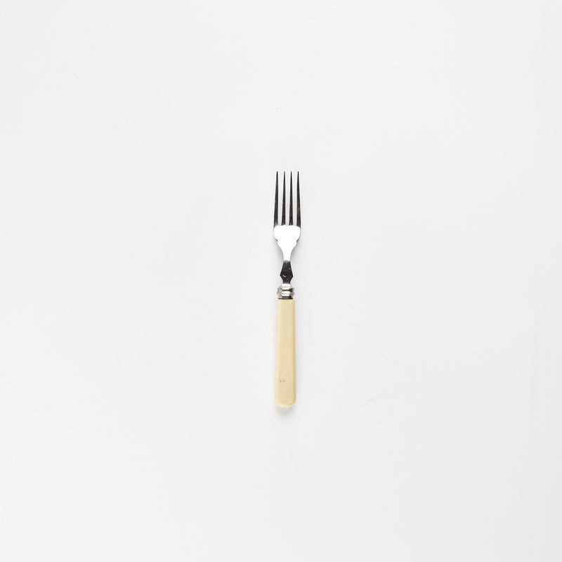 Silver fork with cream handle.