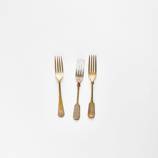 Three antique gold and silver forks.