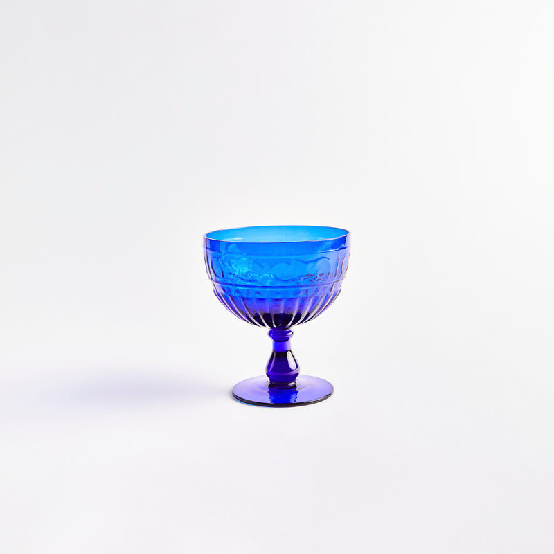 Blue glass display dish with embossed design.