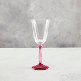 Wine glass with fuchsia stem.