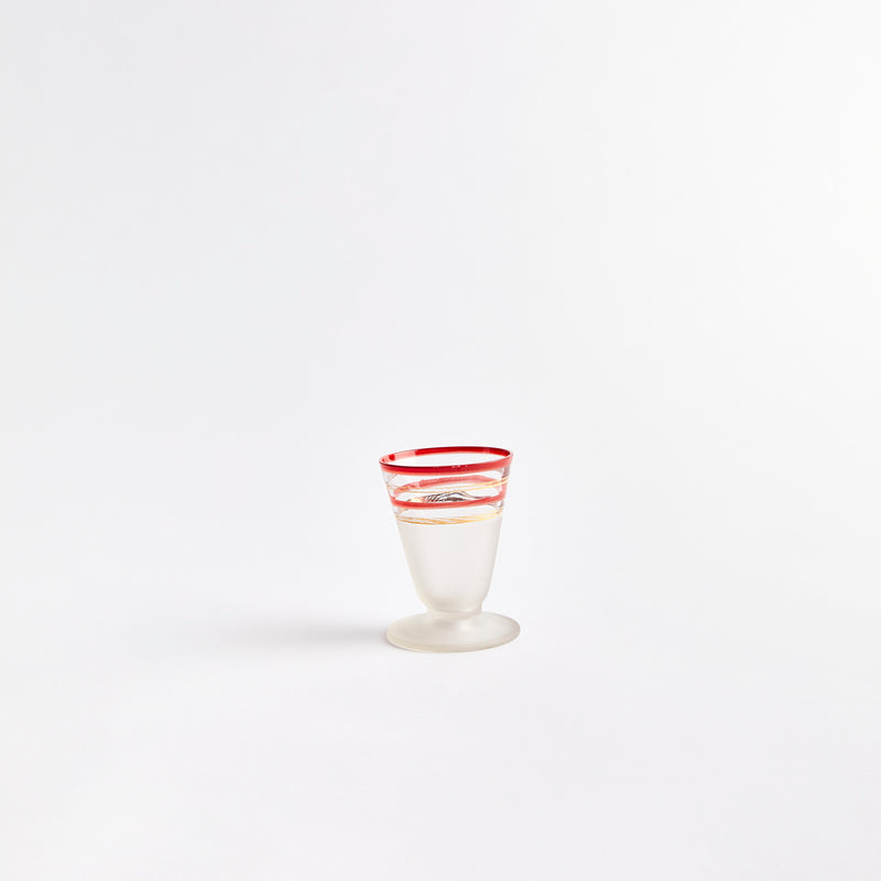 Clear and red shot glass.