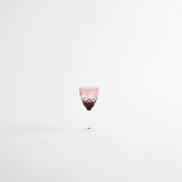 Pink wine glass with etched design.