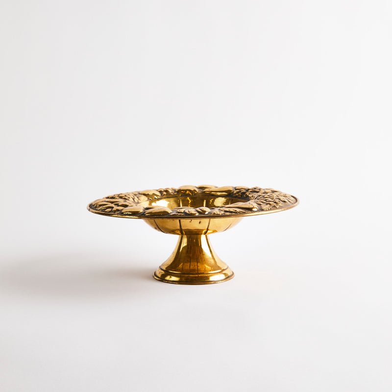 Gold display dish with fruited pattern edge.