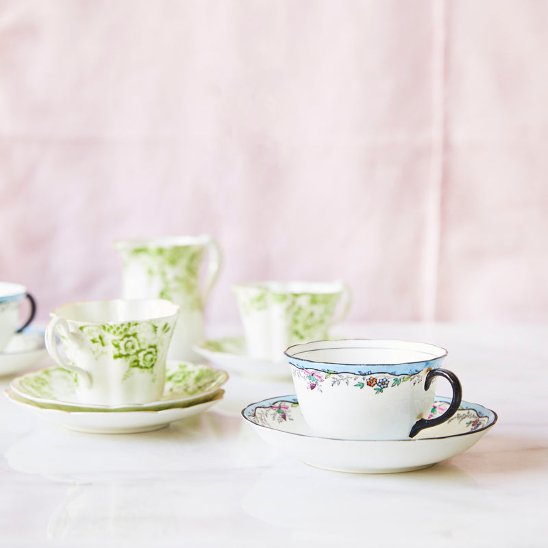 Blue and green tea cups with saucers.
