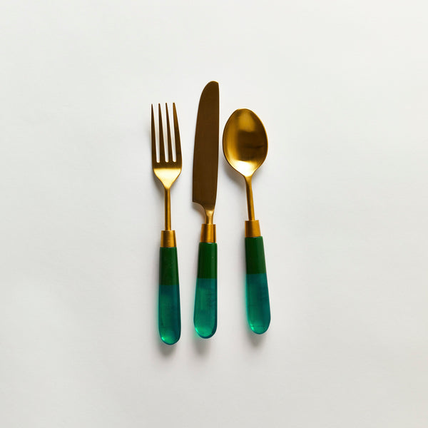Gold serving cutlery with green handle.